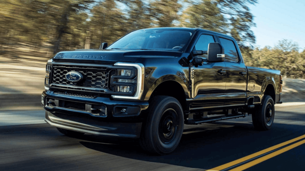 A bold black 2025 Ford Super Duty® F-250 in motion on a scenic road. Experience unmatched towing confidence and power for Cleveland Heights drivers seeking reliability and strength.
