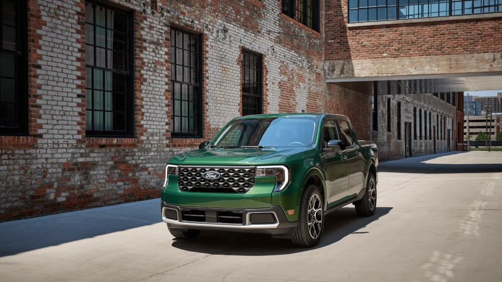 2025 Ford Maverick in green color parked in an urban alley with brick walls and industrial-style buildings.