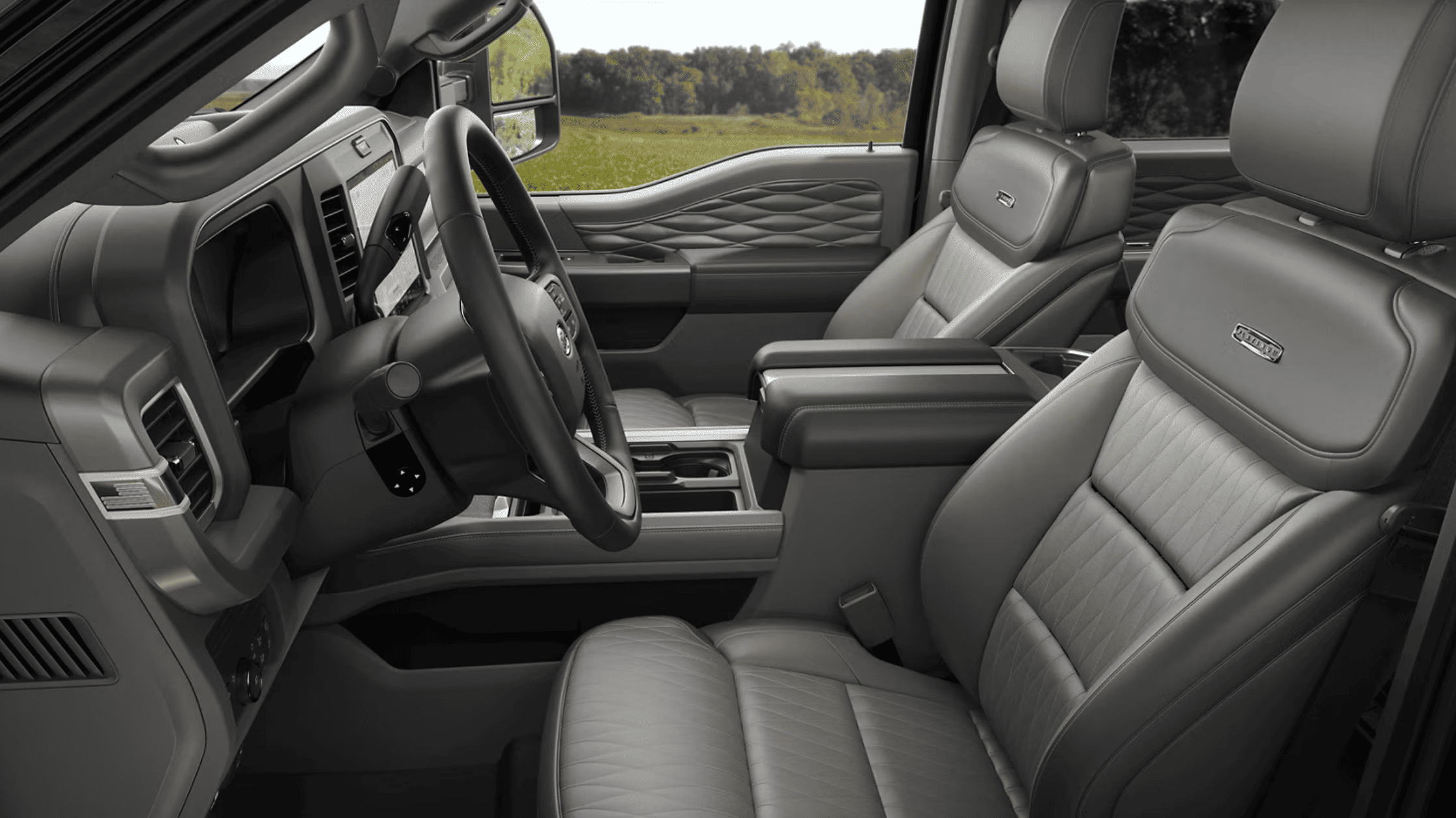 Interior view of the 2025 Ford Super Duty® F-250® LARIAT edition with quilted leather seats, armrest console, and spacious cabin layout.