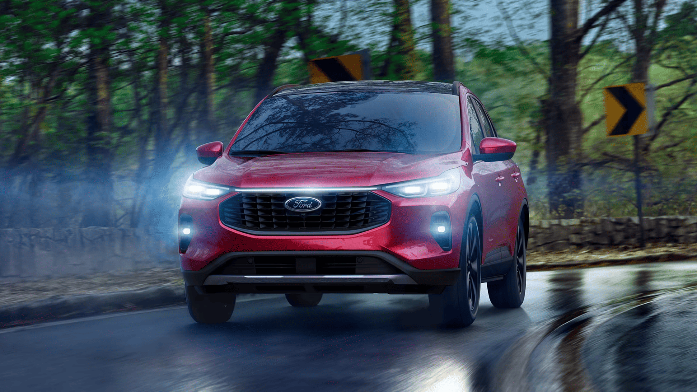 A driver using the high-tech infotainment system in the 2025 Ford Escape®, showcasing a sleek digital interface with navigation, entertainment, and climate control options.