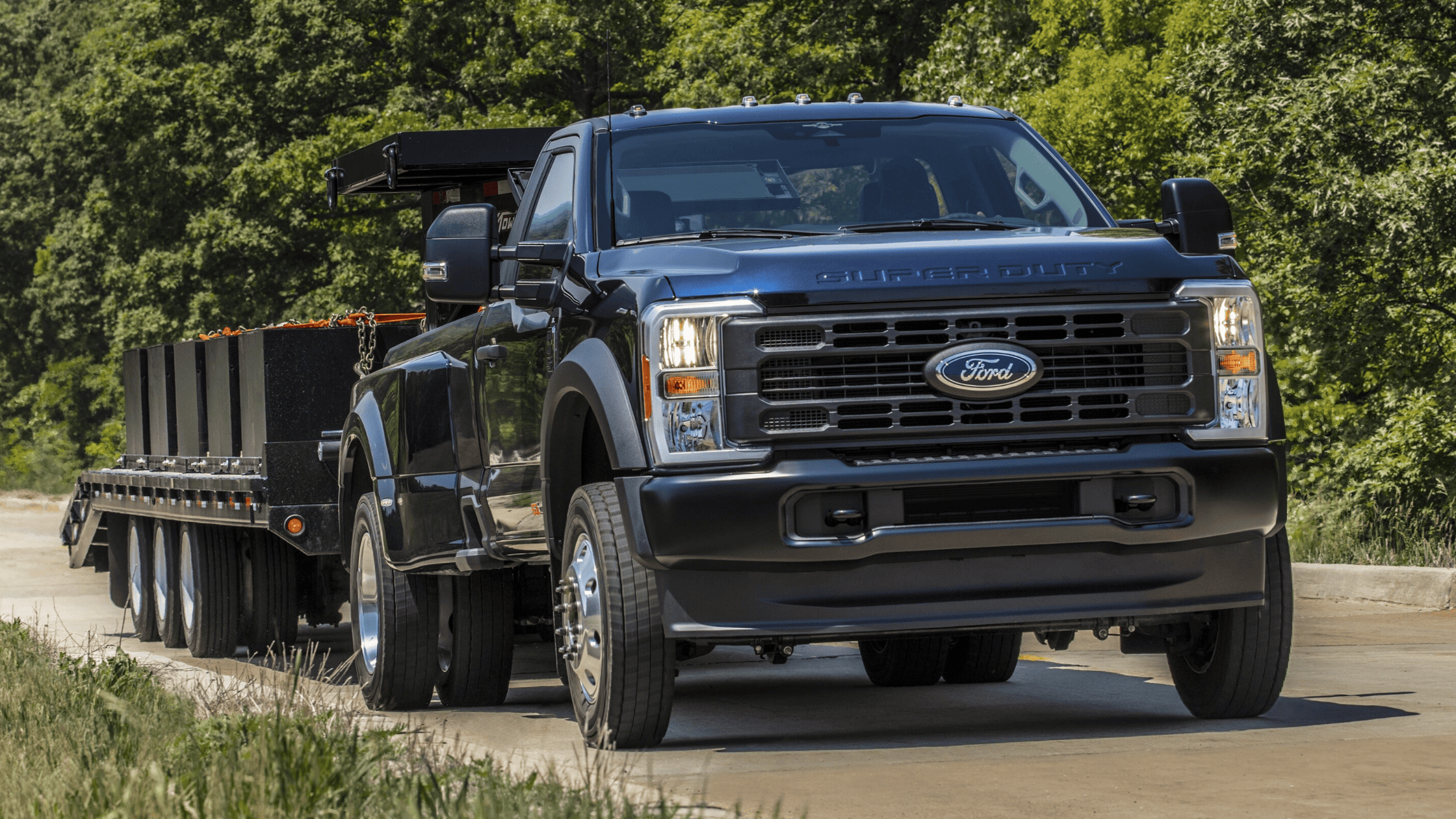 2025 Ford Super Duty® towing a heavy trailer on the road, highlighting its robust power and hauling capability near Mentor, OH.