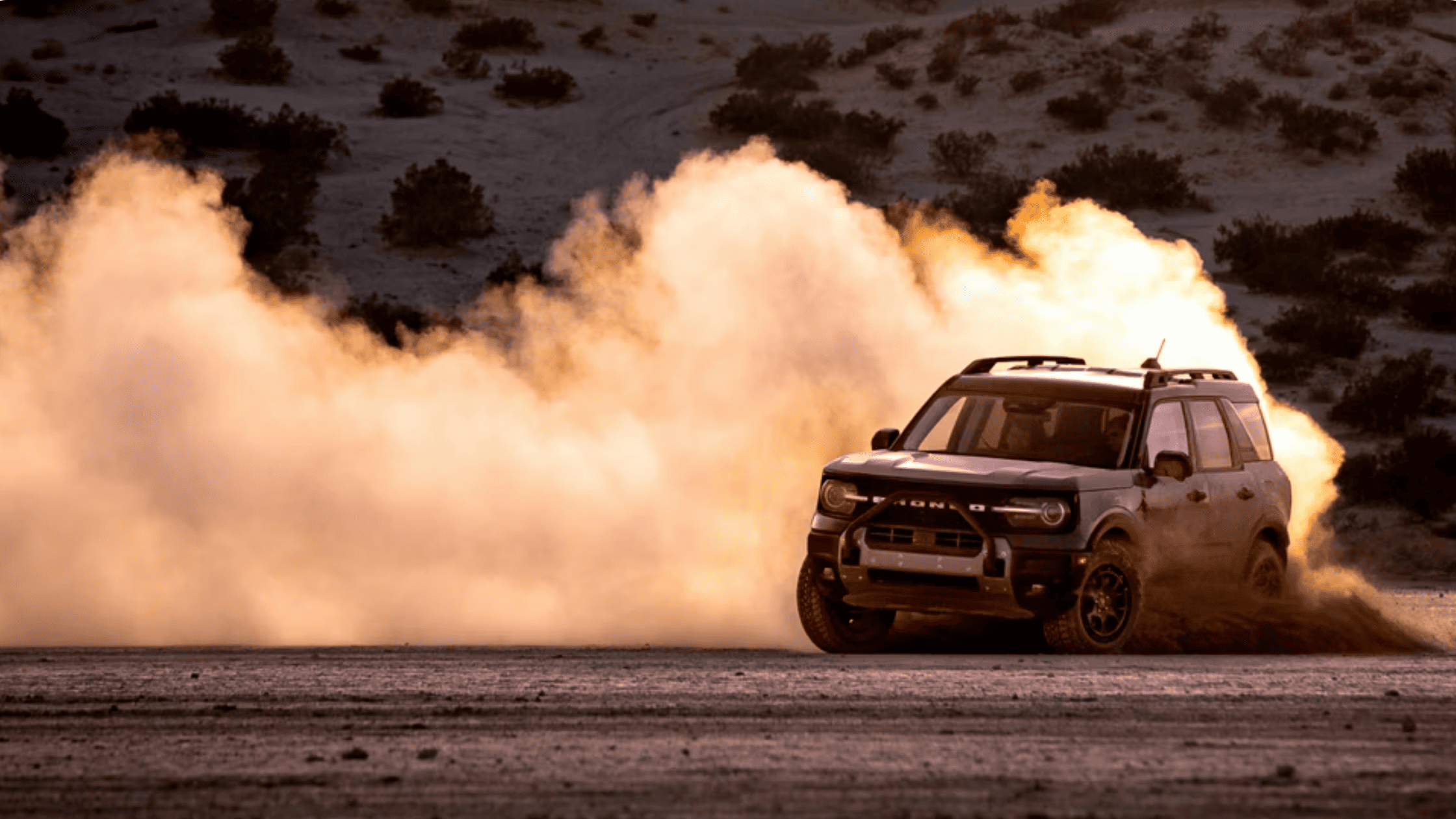 2025 Bronco Sport® kicking up desert dust while drifting on an open off-road trail near Concord, OH.