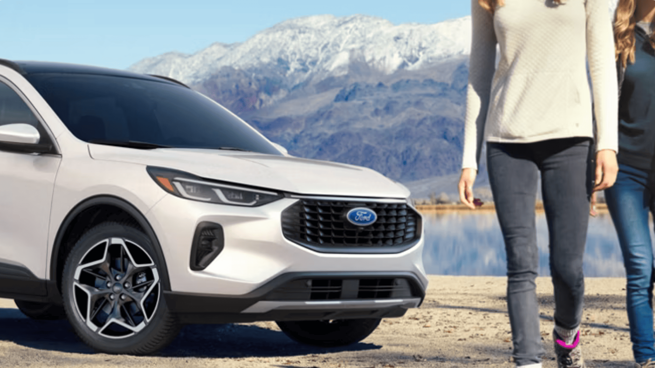 2025 Escape® SUV parked in front of a scenic lake with snow-capped mountain backdrop near Concord, OH.